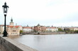 © Martin Debus - Blick von der Karlsbrücke mit alter Straßenlaterne auf die Moldau und die Altstadt von Prag mit Altstädter Wasserturm und Bedrich Smetana Museum mit Wolken bei Regenwetter im Frühling in Tschechien