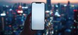 Hand holding smart phone with clean white blank screen mockup with city skyline defocused background for technology and app concepts