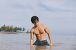 © SHOTPRIME STUDIO - Active Asian Man Having Fun Swimming in the Tropical Blue Water on a Beach Vacation