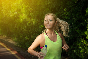 Wall Mural - fitness woman training and jogging in summer park. healthy and sport concept