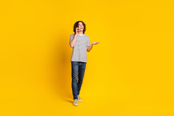 Sticker - Full size portrait of nice young man walk speak phone wear striped t-shirt isolated on yellow color background