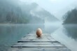 Serenade of Dawn: Easter Egg on Misty Lake Dock. Concept Travel Photography, Sunrise Serenity, Holiday Celebration, Natural Beauty, Water Reflections