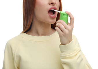 Poster - Young woman using throat spray on white background, closeup