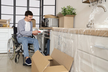 Sticker - Young man in wheelchair repairing kitchen drawer at home