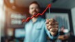 © Natalia S. - A businessman in a blue shirt is holding a red arrow graph. The arrow is on a string being pulled by the man, shows financial growth of savings and investments in investments, income growth