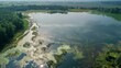 A oncebeautiful lake now appears murky and lifeless due to a biofuel plantation located nearby emphasizing the negative impact of agricultural practices on freshwater ecosystems. .