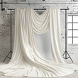 A white curtain is draped over a wall, creating a sense of elegance and sophistication. The curtain is long and flowing, giving the impression of a grand entrance or a luxurious setting