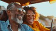 Visualize a dynamic, mixed-race couple in their 60s, setting out on a road trip in their electric car, surrounded by the vibrant greens of the American countryside in spring.