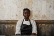 Young african american woman barista in apron at coffee shop