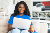Fototapeta  - Pretty corpluent black female student learning at computer