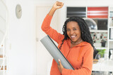 Fototapeta  - Portrait of successful cheering black woman with yoga mat