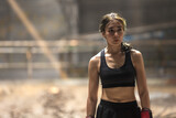 Fototapeta Natura - Portrait young confident Asian Muay Thai boxer woman 