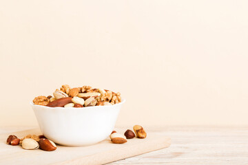 Canvas Print - mixed nuts in bowl. Mix of various nuts on colored background. pistachios, cashews, walnuts, hazelnuts, peanuts and brazil nuts