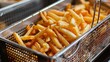 Close up of perfectly cooked french fries in a deep fryer, crispy and golden fries