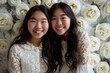  Two young Asian women posing on white roses background for a photo. Fictional Character Created by Generative AI.
