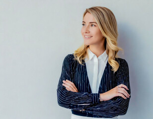 Young woman portrait blonde girl arms crossed over grey wall background smiling looking aside