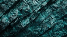 A Dense, Dark Teal Rocky Surface That Looks Like The Side Of A Mountain. The Texture Is Rugged And Natural, With Various Shades Of Teal Adding Depth. 