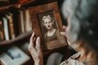 © Wirestock - Old lady looking at an old ruined photograph from when she was a young girl, AI-generated.