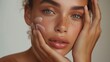 Skincare ad beautiful model with amazing skin touching her face gently