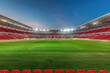 An empty soccer stadium with red seats and green grass field, night time.