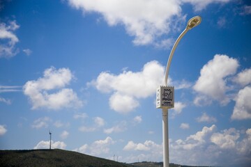 Closeup view of a street light against a clear blue sky background