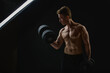  Muscular man with dumbbells on black background. Muscular man with dumbbells on black background.  Absolutely unedited RAW file. No body and environment retouched photography.