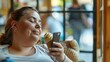 Side view of obese woman enjoying leisure time with a mobile phone and ice cream cone