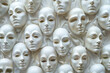© grey - A collection of emotionless white masks on a white wall