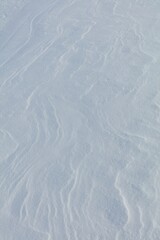 Wind has made patterns on snow surface.