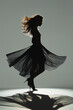 A woman in a black dress is dancing in the air