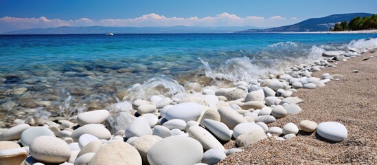 Poster - Rocks and water create a scenic beach view