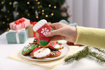 Wall Mural - Woman with decorated Christmas cookie at table, closeup