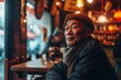 Portrait of an elderly Chinese man sitting in a restaurant and looking at the camera.