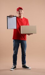 Wall Mural - Happy courier with parcel on beige background