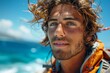 Smiling young kite surfer with blue eyes and unruly curly hair wearing an orange jacket by the ocean