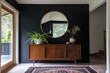 A midcentury modern sideboard with a round mirror hanging above it, in the entrance hall of an old minimalist house with dark walls and a white ceiling, in the style of midcentury modern.