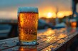 A delightful beer glass with bubbling froth set against a captivating sunset over the sea, signifying a peaceful end to the day