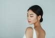 © Kien - A young Asian woman with smooth skin and shoulder-length straight hair, wearing white for beauty care, poses on the right side against a clean background