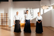 Martial Arts Instructors Poised in Traditional Dojo Standing Confidently