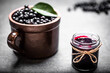 Aronia jam and fresh berry on stone table.