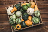 Fototapeta Kuchnia - Fresh pumpkins in wooden box. Gourds an squashes. Decorative vegetables harvest. Autumn Thanksgiving decorations.