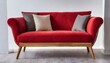 A staple food in the world of comfort, a red couch with wooden legs on a white background