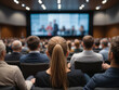 © JL stock - Back shot of a group of people seated on chairs in a conference room in front of a screen. Concept for business training