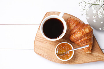 Sticker - Tasty breakfast. Cup of coffee, jam and croissant on white wooden table, top view. Space for text