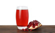 Refreshing pomegranate juice in glass and seeds on wooden table against white background