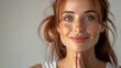 Serene redhead woman practicing mindfulness: tranquil red-haired woman with hands in prayer position, embodying a peaceful mindfulness concept. Namaste mood, looking at camera