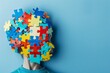 Autism awareness. child head with jigsaw puzzle pieces on blue background, world autism day concept