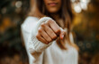 Aggressive woman punching with fist, blurred background	