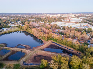 Wall Mural - Aerial landscape of forest and pond at sunset in Augusta Georgia