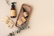 Eco-friendly selfcare accessories concept with loofah sponges, cosmetic glass bottles and eucalyptus